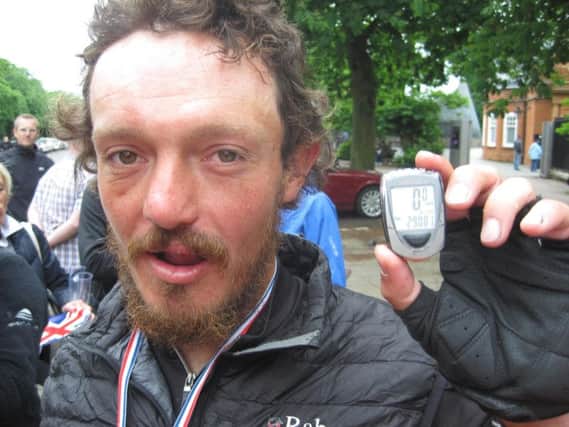 Mike Hall with his pedometer at Greenwich Royal Observatory in south-east London after he won a round-the-world bike race in 2012