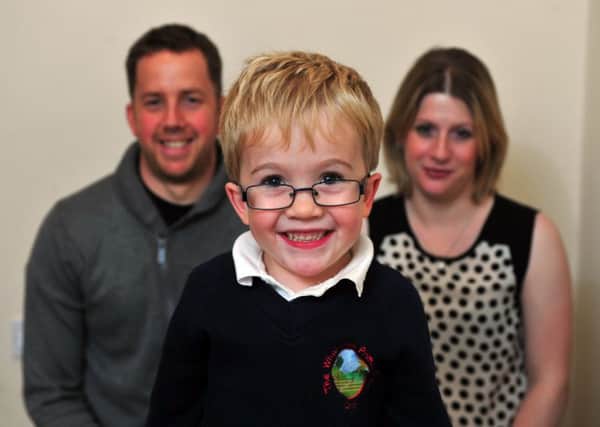 Sam Brown, now eight, with parents Katy and Simon from Otley. Pictured in 2014.