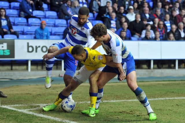 1CORNER BALL: Leeds United's Kemar Roofe tussles wiith Reading's Lewis Grabban and John Swift. Picture: Tony Johnson.