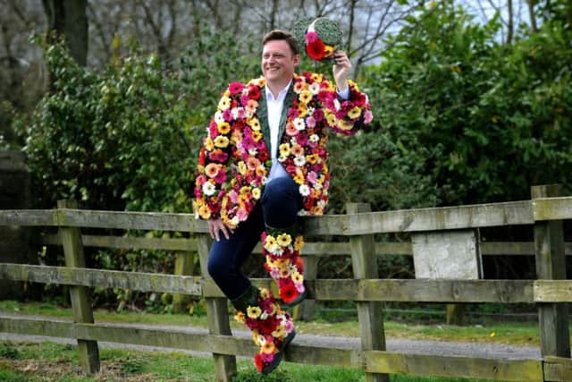 Show director Nick Smith dons a coat of many flowers, to launch national Wear a Flower day. Picture Jonathan Gawthorpe