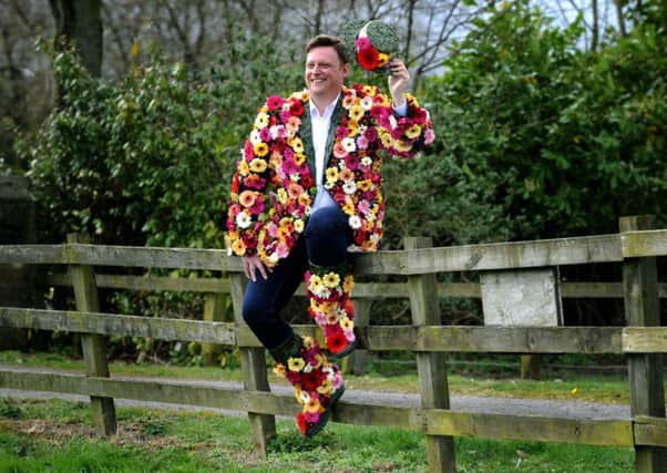 Show director Nick Smith dons a coat of many flowers, to launch national Wear a Flower day. Picture Jonathan Gawthorpe