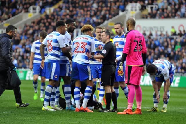 Royals players crowd referee Keith Stroud after Reece Oxford's clash with United's Liam Cooper.