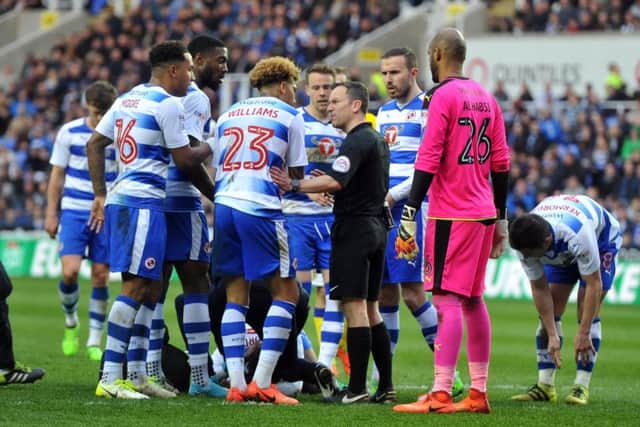 Reading players surround referee Stroud after Liam Cooper's challenge on Reece Oxford.