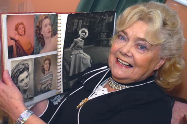Doreen Fletcher with some of her modelling photographs.