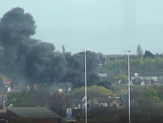 Smoke billows out from the scene of the fire in Beeston