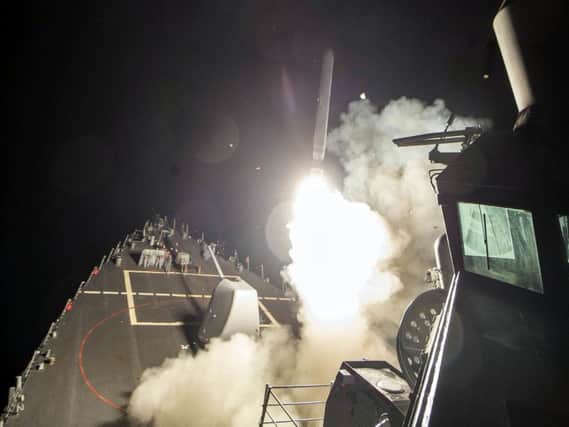 The USS Ross (DDG 71) fires a tomahawk land attack missile toward Syrian.