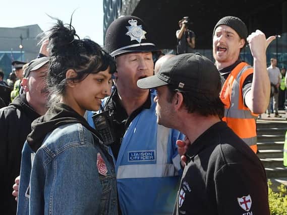 Saffiyah Khan (left) staring down English Defence League (EDL) protester Ian Crossland during a demonstration in Birmingham.