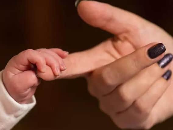A coroner has warned parents not to sleep in bed with new-born babies.