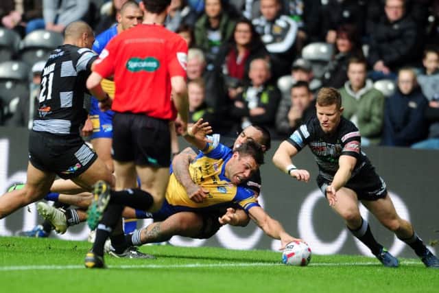 Leeds Rhinos' Joel Moon dives over to score a try in the first period. Picture: Tony Johnson.
