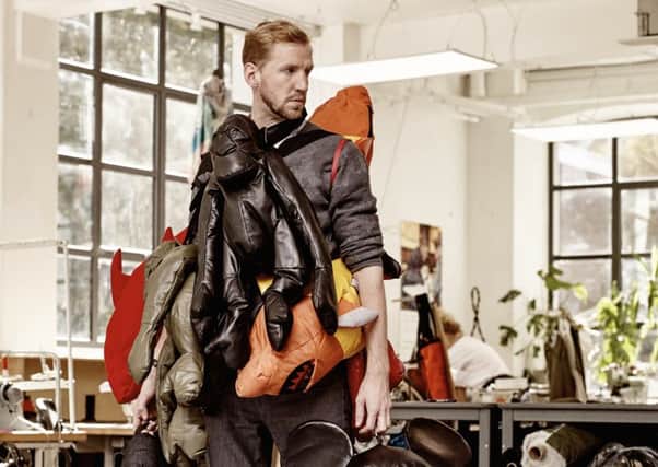 Sustainable fashion guru Christopher Raeburn, with some of his animals made from offcuts.