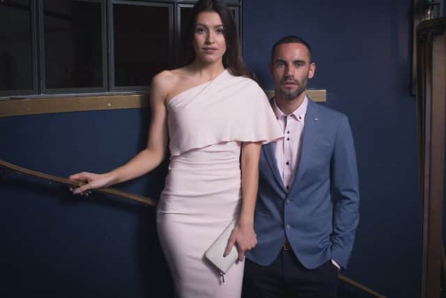 The One-Shoulder Cape Dress: Really dressy and sophisticated, with its statement one-bare-shoulder style (often classier than both) but given a demure edge with a cape or deep panel frill over the bust area. It's definitely a look that says "look at me", but which also keeps something back, adding an air of mystery. Ideal both for those who like to be seen and not heard too much, and those who secretly see a wedding as a flirting opportunity.
Pink one shoulder dress, £244.99, by Kevan Jon, and his outfit, all at Accent Clothing.