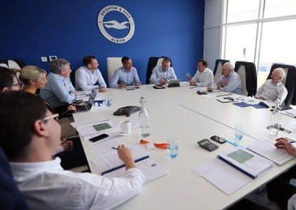 Brighton boss Chris Hughton and board members get together after the club missed out on promotion last season.