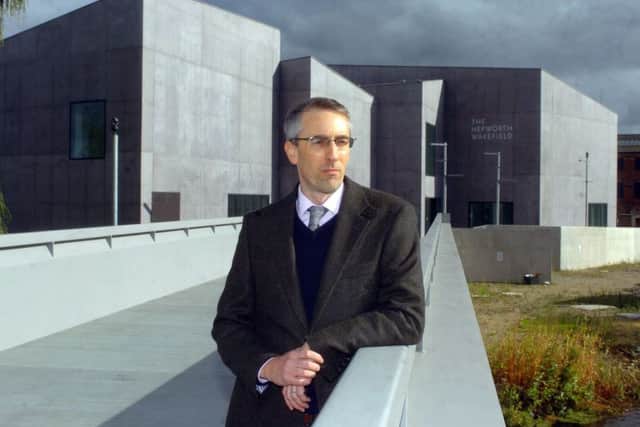 Director Simon Wallis in front of the building.