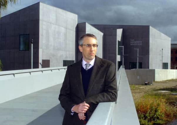 Director Simon Wallis in front of the building.