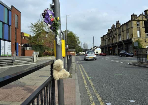 Flowers and a teddy bear at the scene where Yusupha Jatta was knocked down.