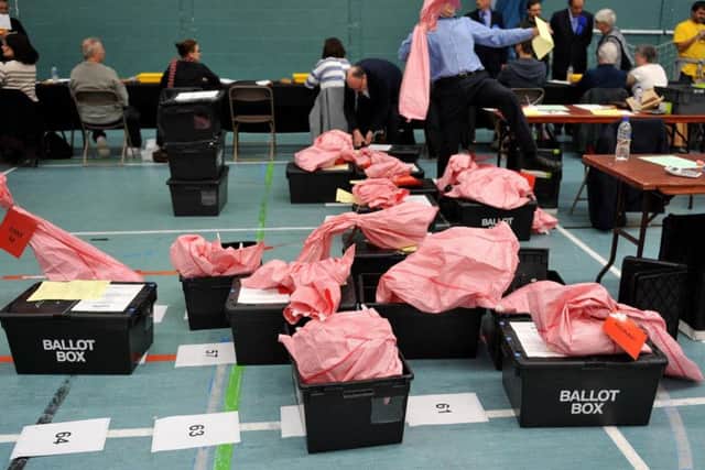 Election count staff sort ballot boxes during the local election count at Riverside Ice & Leisure Centre in Chelmsford, Essex.