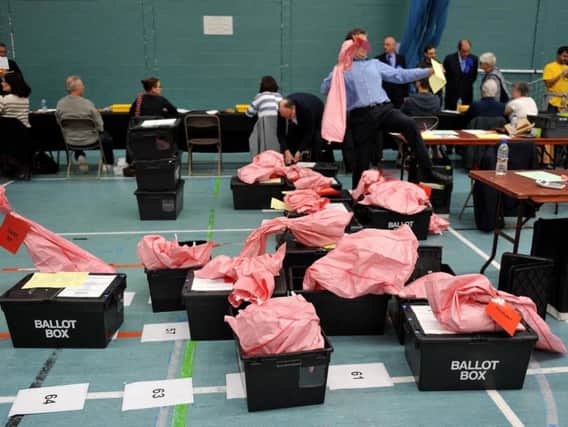 Election count staff sort ballot boxes during the local election count at Riverside Ice & Leisure Centre in Chelmsford, Essex.