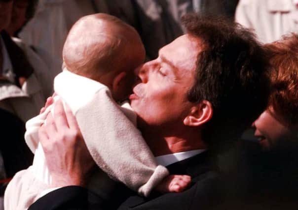 Library picture dated 15/04/97 of nine month old James Austin being kissed by Labour Party leader Tony Blair during a walkabout at The Broadway, Crawley. James, now 5, handed a letter to Cherie Booth, at the famous door of 10 Downing Street, London, Monday 22 July 2002. He has written a letter to ask for his school, Three Bridges First School, Crawley in West Sussex, to be saved from a cost cutting merger. James was famously pictured as a baby being held by Tony Blair in the 1997 election campaign. See PA story EDUCATION School. PA Photo: Sean Dempsey.