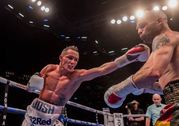 LONG NIGHT: 
Josh Warrington puts in a long left-arm jab against Kiko Martinez in front of his hometown crowd at the First Direct Arena, Leeds. Picture: James Hardisty