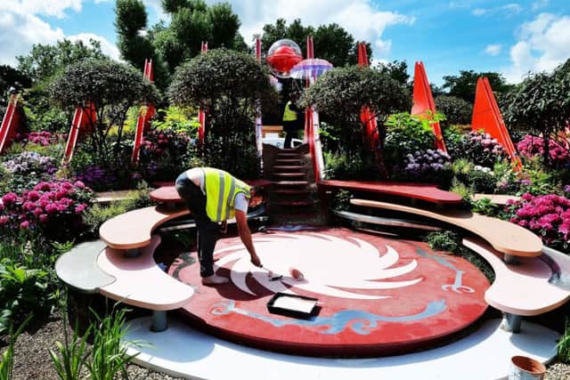 FINISHING TOUCHES: An exhibitor works on final preparations at the world famous RHS Chelsea Flower Show in London before the event opens to the public.