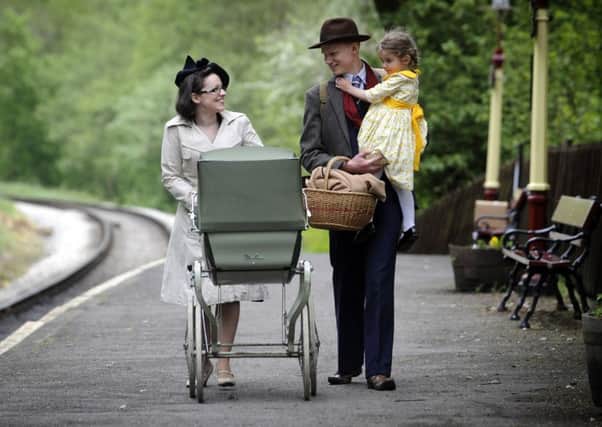 LOOKING BACK: David and Isobel Robinson with their daughter Evie, four, on the platform at Haworth Railway Station.