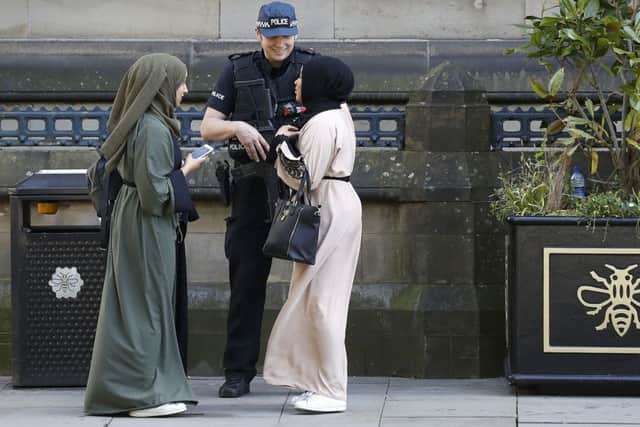 Armed police stand guard at Albert Square, Manchester, after a suicide bomber killed 22 people, including children, as an explosion tore through fans leaving a pop concert in Manchester. PIC: PA