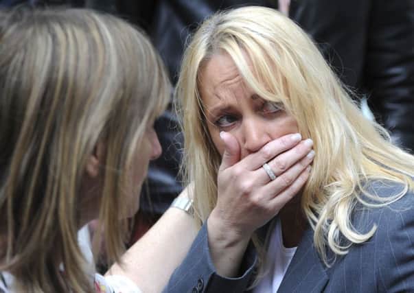 A member of the public reacts as police evacuate the Arndale shopping centre in Manchester. PIC: PA