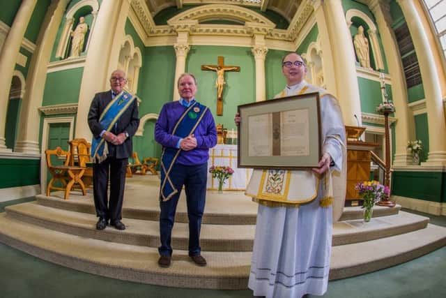 Date: 17th May 2017.
Picture James Hardisty.
A handwritten blessing for a Yorkshire church sent by Pope Pius X in 1908 has been uncovered in an attic after being lost for 60 years and has been presented back to the parish priest at St Austin's Church, Wentworth Terrace, Wakefield. Pictured (left to right) Norman Hazell, President of the Catholic Young Mens Society, and Michael Timlin, Secretary of the Catholic Young Mens Society with Monsignor David Smith, holding the discovered letter.