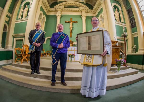Date: 17th May 2017.
Picture James Hardisty.
A handwritten blessing for a Yorkshire church sent by Pope Pius X in 1908 has been uncovered in an attic after being lost for 60 years and has been presented back to the parish priest at St Austin's Church, Wentworth Terrace, Wakefield. Pictured (left to right) Norman Hazell, President of the Catholic Young Mens Society, and Michael Timlin, Secretary of the Catholic Young Mens Society with Monsignor David Smith, holding the discovered letter.