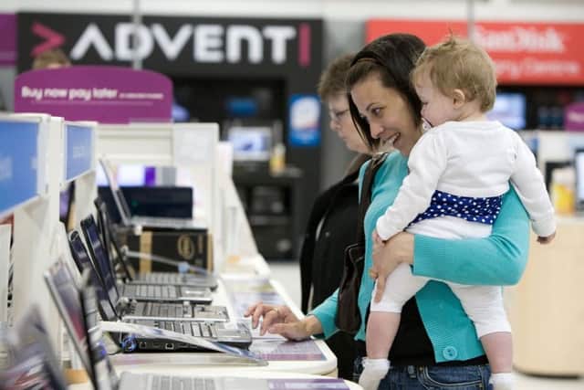 A Dixons Carphone Currys Customer browsing laptops.