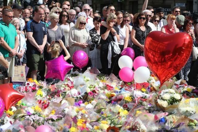 People observe a minute's silence in St Ann's Square, Manchester. PIC: PA