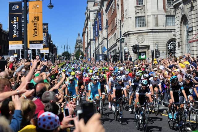 Mark Cavendish leads the cyclists down the Headrow at the Start of the Tour De France, 6th July, 2014.