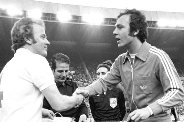 Billy Bremner and Franz Beckenbauer shake hands before the game.