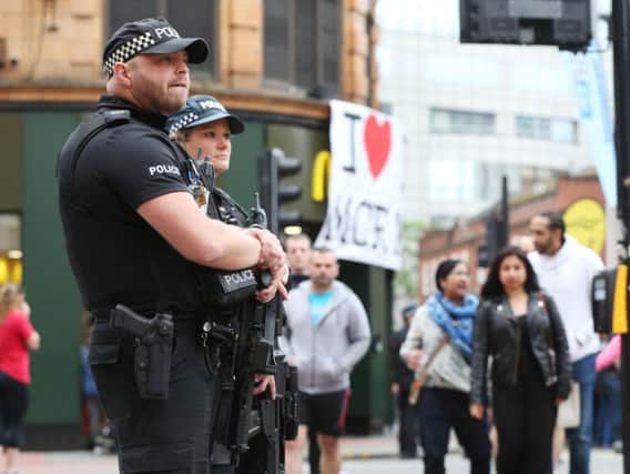 Armed police on duty in Manchester. PA