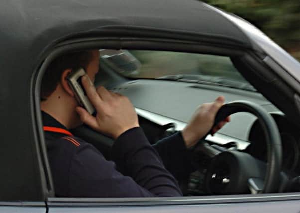 Hundreds of motorists are being caught using their mobile phones illegally every day, figures have revealed. Pic: PA.