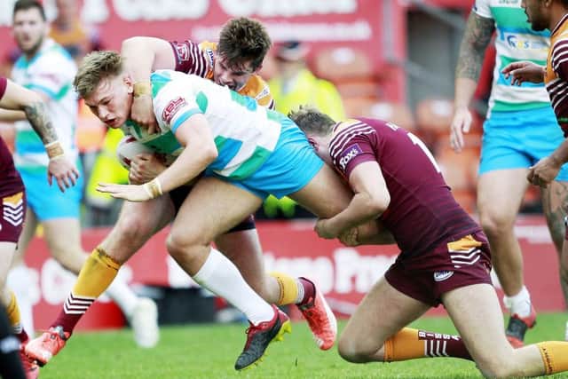 Batley's Daniel Cowling and James Harrison  tackle Dewsbury's Billy Hayes. Picture: SWpix.com