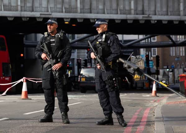 Armed police guard an area close to Borough Market in London following Saturday's attack. PIC: PA