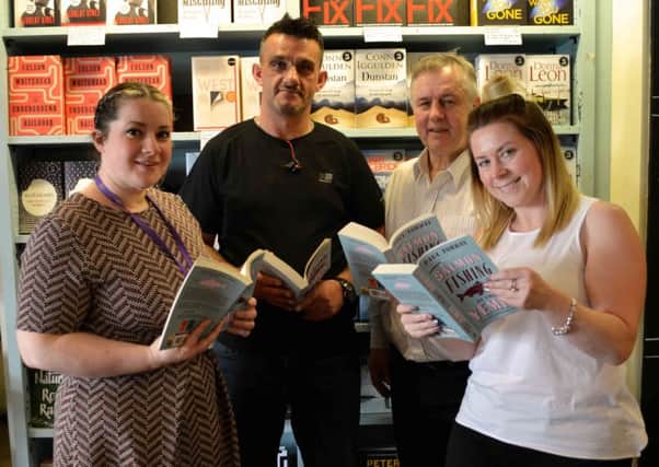 Gemma Patterson and Becky Carroll from Forward Leeds, with client John Moore and Waterstones branch manager Ged Rumfitt.