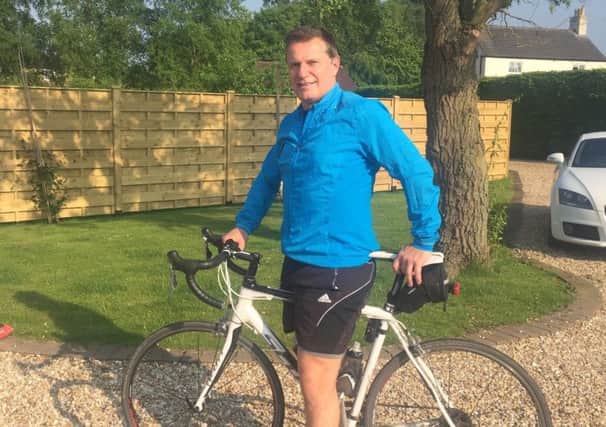 Relief: Tony Britton, 54, who now cycles and walks every day after undergoing surgery to correct a curve in his spine.