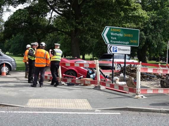 Police are on the scene where a car has crashed into the excavated hole. Picture: David Simister