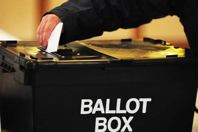Voters placed their ballot in a car park