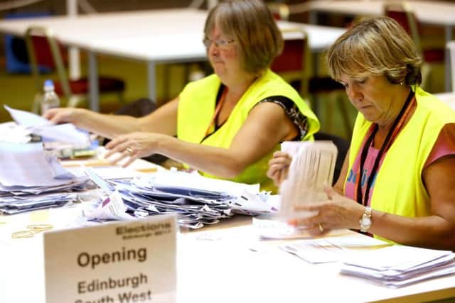 Election staff sort postal votes ahead of the General Election count at Meadowbank Sports Centre in Edinburgh. PA