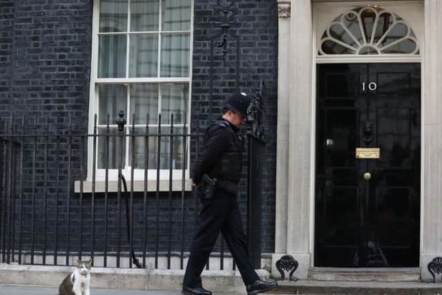 Larry the cat and a policeman outside 10 Downing Street, London, as Theresa May's future as Prime Minister and leader of the Conservatives was being openly questioned after her decision to hold a snap election disastrously backfired. PRESS ASSOCIATION Photo. Picture date: Friday June 9, 2017.  Photo: Jonathan Brady/PA Wire