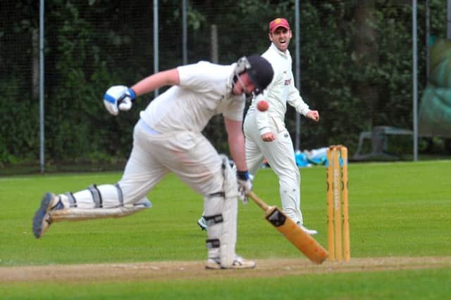 Alex Baldwin takes evasive action for New Farnley as Woodlands' Sam Frankland tries to run him out. PIC: Steve Riding