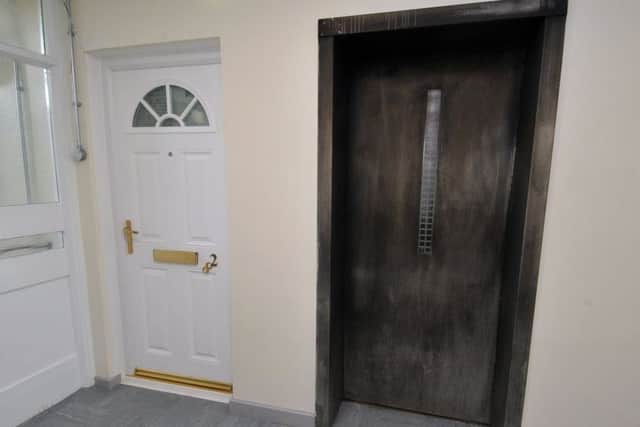 Smoke damage is still visible on the lift doors in Poplar Mount, Bramley.