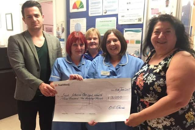 Ornella and Antony Davies present a cheque for Â£3,200 to members of Leeds General  Infirmary's Intensive Care Unit. The money was raised by the Richard Davies' memorial charity football event