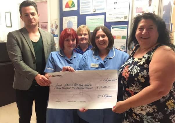 Ornella and Antony Davies present a cheque for Â£3,200 to members of Leeds General  Infirmary's Intensive Care Unit. The money was raised by the Richard Davies' memorial charity football event