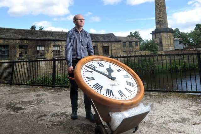 CLOCKING ON: Curator John McGoldrick with the clock. PIC: Tony Johnson