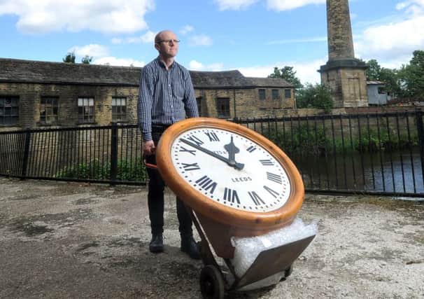 CLOCKING ON: Curator John McGoldrick  with the clock. PIC: Tony Johnson