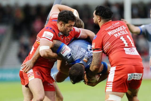 Wakefield's Anthony England is brought down to earth by Salford's Kriss Brining, Mark Flanagan and Ben Murdoch-Masila.